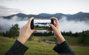 woman-taking-photo-rural-surroundings